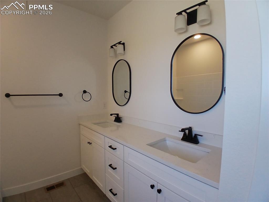 19981 Cloudfield Point Colorado Springs, CO 80928 - Photo 19 of 42 a bathroom with a sink and a mirror