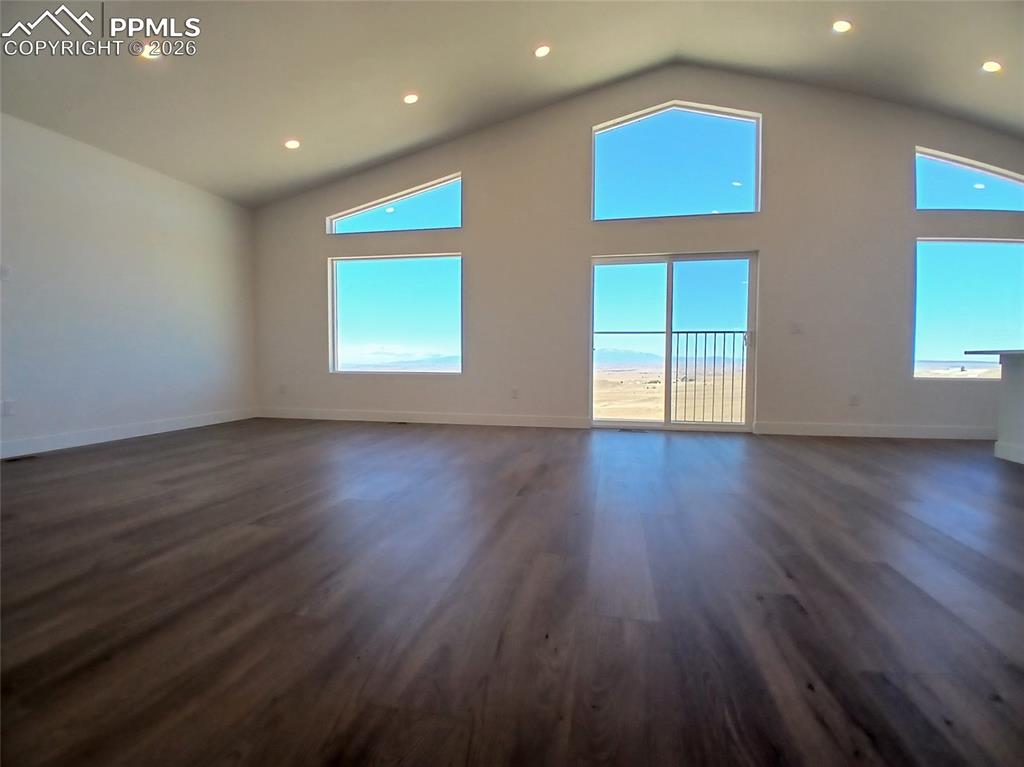 19981 Cloudfield Point Colorado Springs, CO 80928 - Photo 2 of 42 an empty room with wooden floor and windows