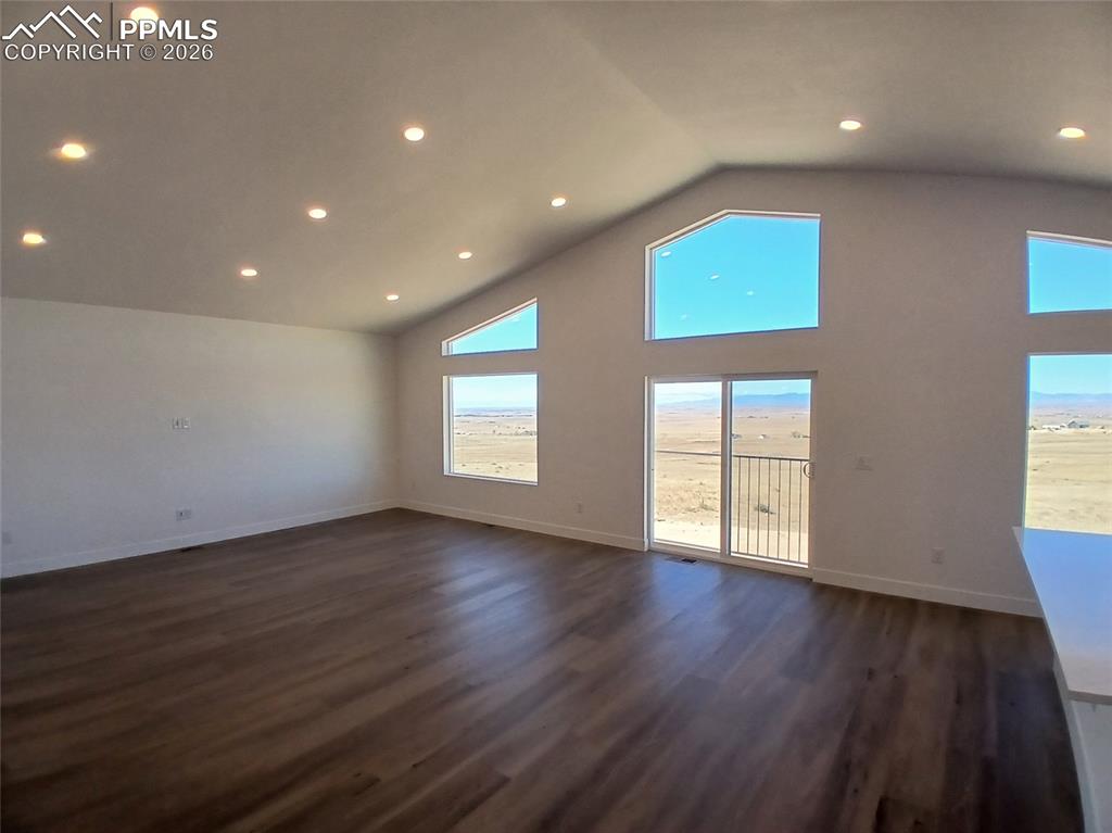19981 Cloudfield Point Colorado Springs, CO 80928 - Photo 5 of 42 an empty room with wooden floor and windows