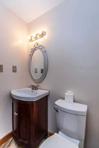 a bathroom with a sink toilet and mirror