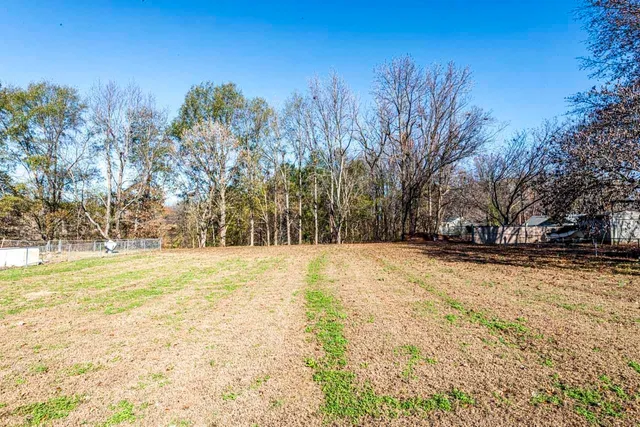 a view of yard covered with snow in front of house