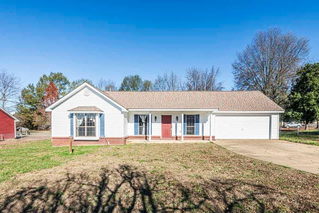 a front view of house with yard and green space