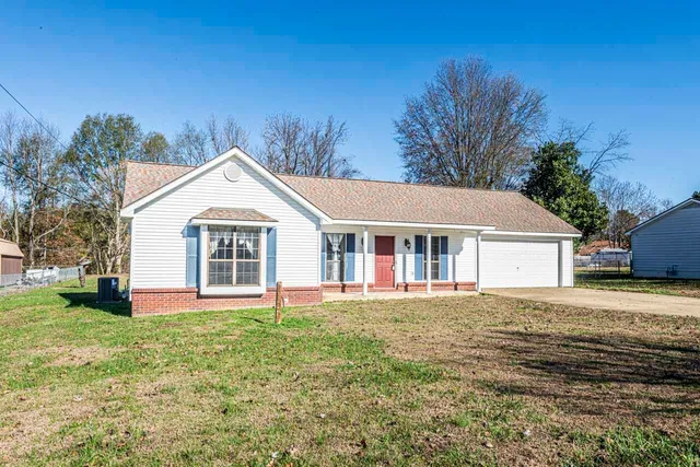 a front view of house with yard and green space