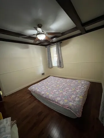 a bed sitting in a room next to a window