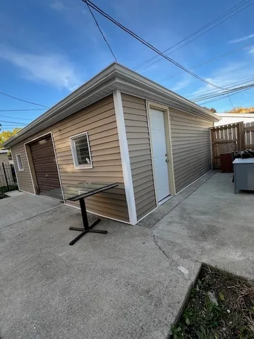 a view of a house with wooden fence