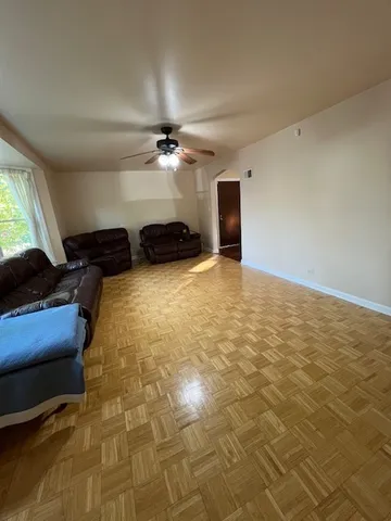a view of livingroom with hardwood floor and a ceiling fan