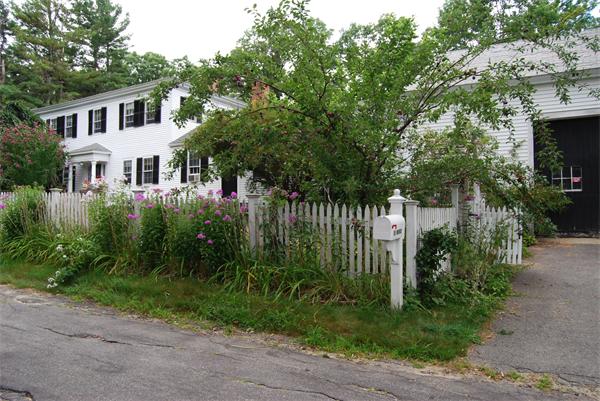 90 Nourse Road Ashby, MA 01431 - Photo 2 of 27 a front view of a house with a garden