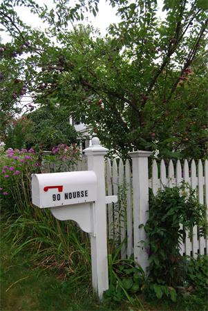 90 Nourse Road Ashby, MA 01431 - Photo 21 of 27 a sign that is sitting in front of flowers