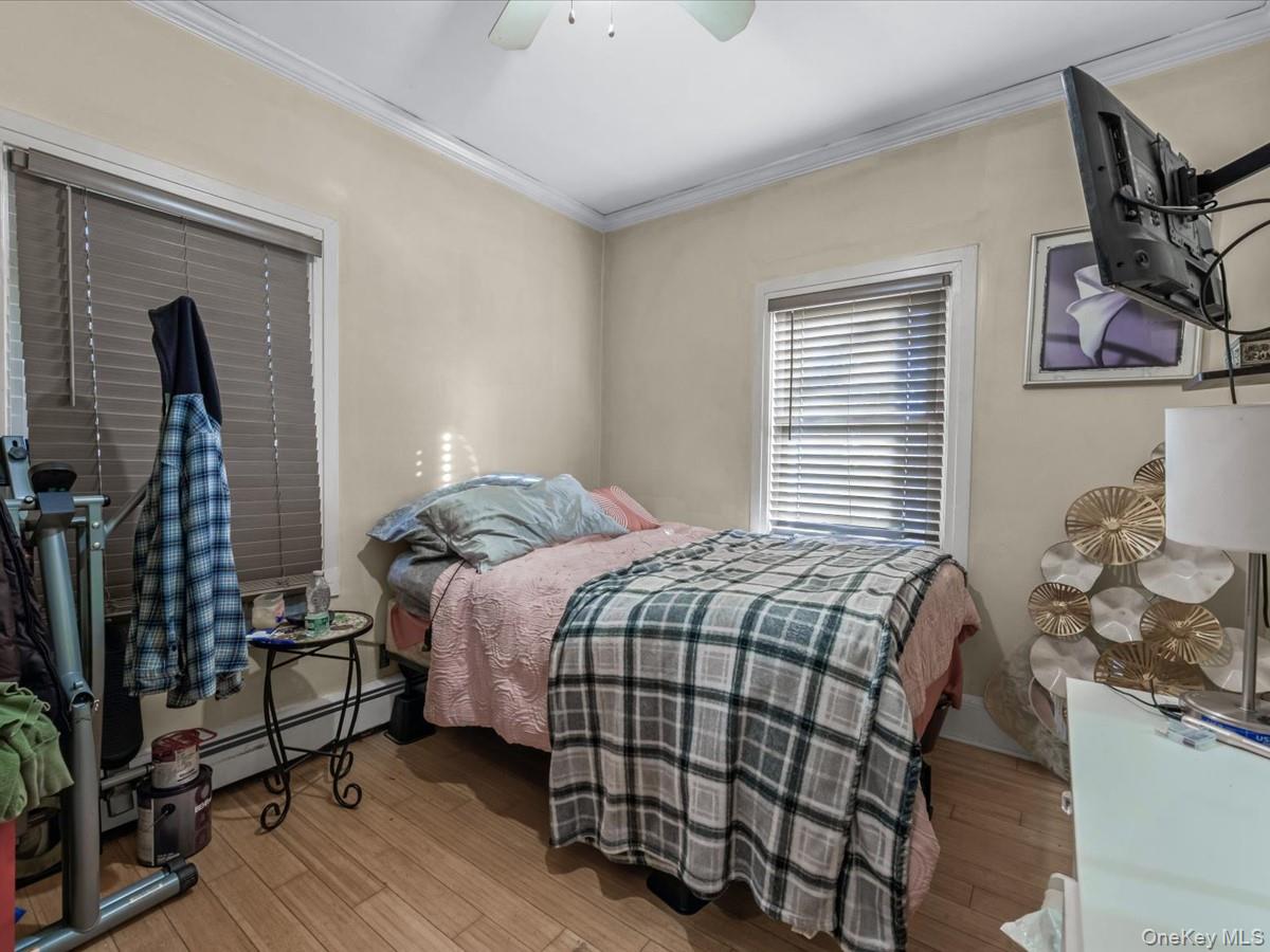 29 Parkside Avenue Miller Place, NY 11764 - Photo 11 of 14 a bedroom with a bed and wooden floor