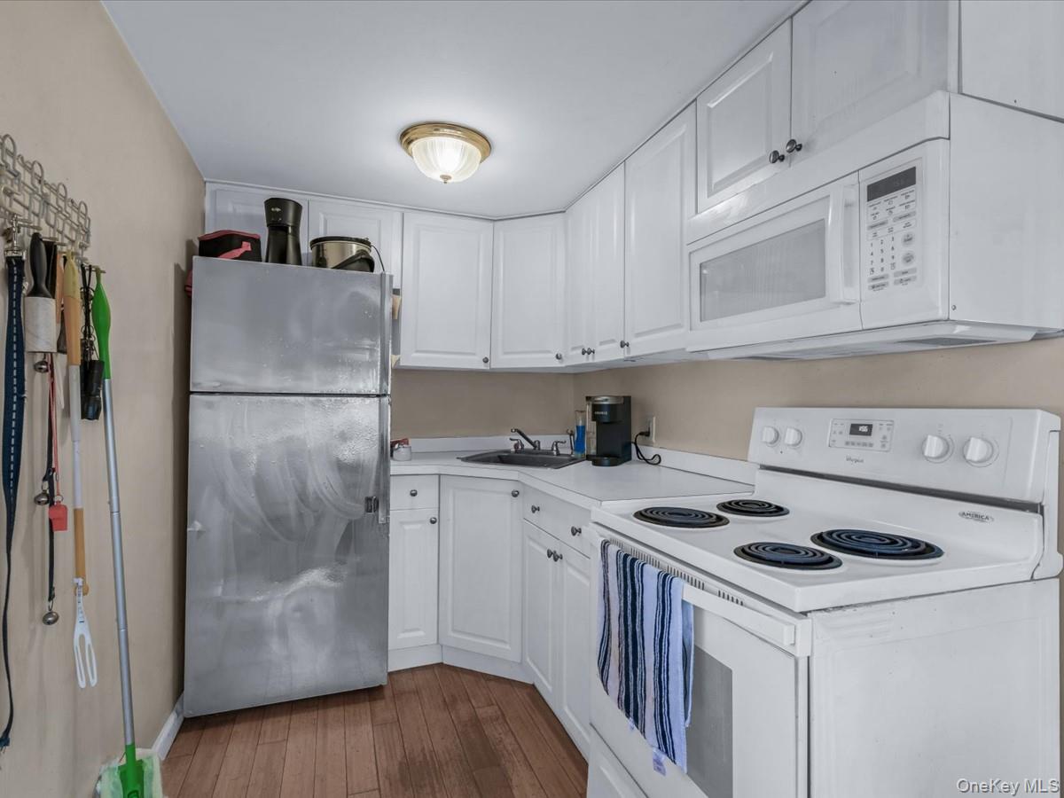 29 Parkside Avenue Miller Place, NY 11764 - Photo 9 of 14 a kitchen with a white cabinets stove and refrigerator