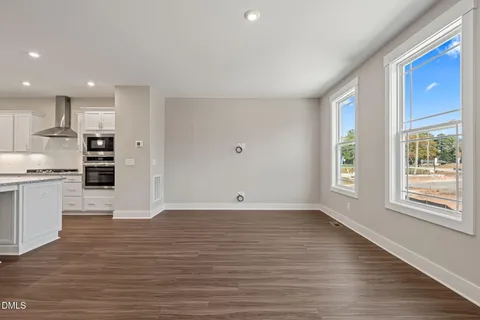 a view of kitchen with wooden floor and electronic appliances
