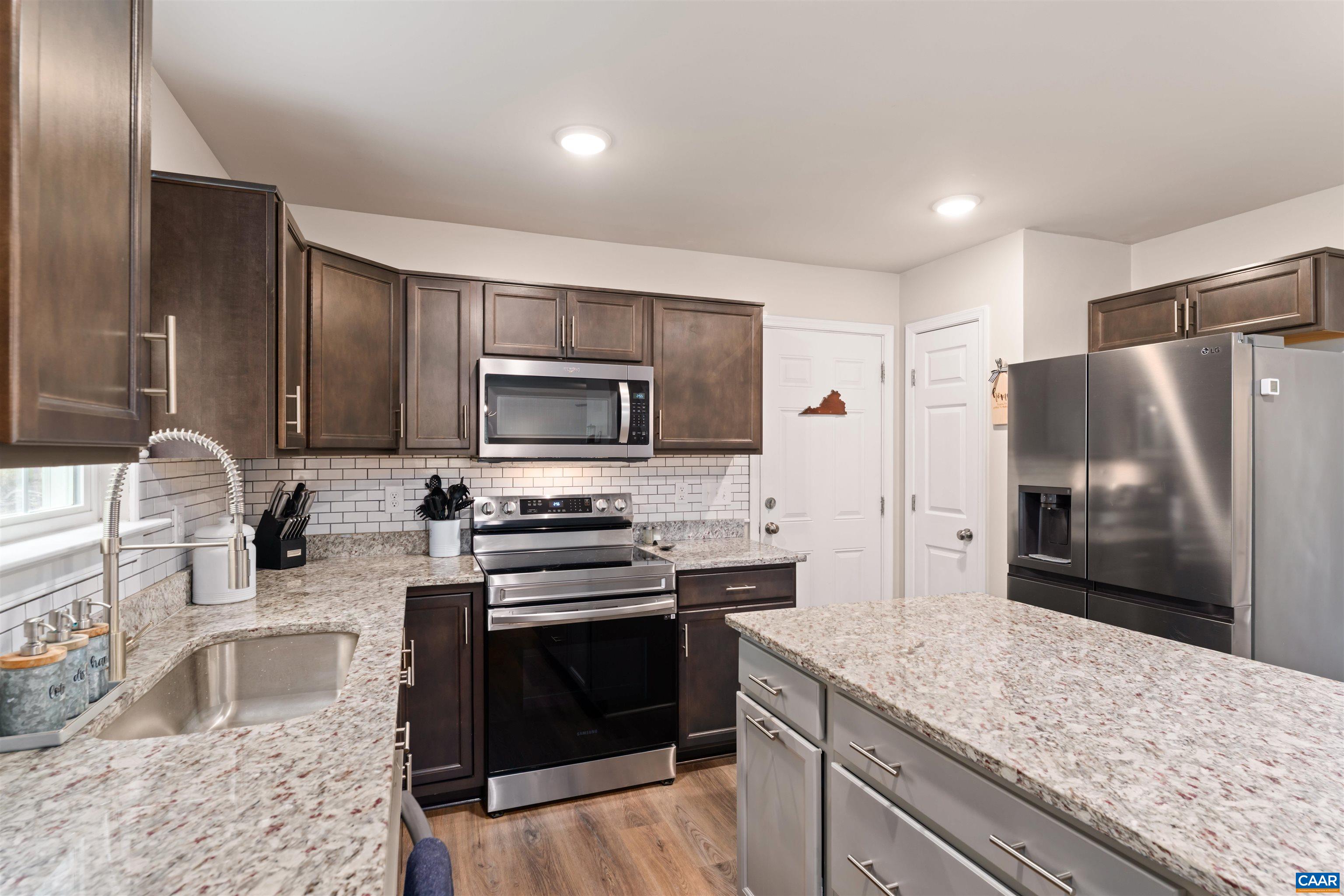 1760 Haden Martin Road Palmyra, VA 22963 - Photo 24 of 51 a kitchen with granite countertop a stove sink and refrigerator