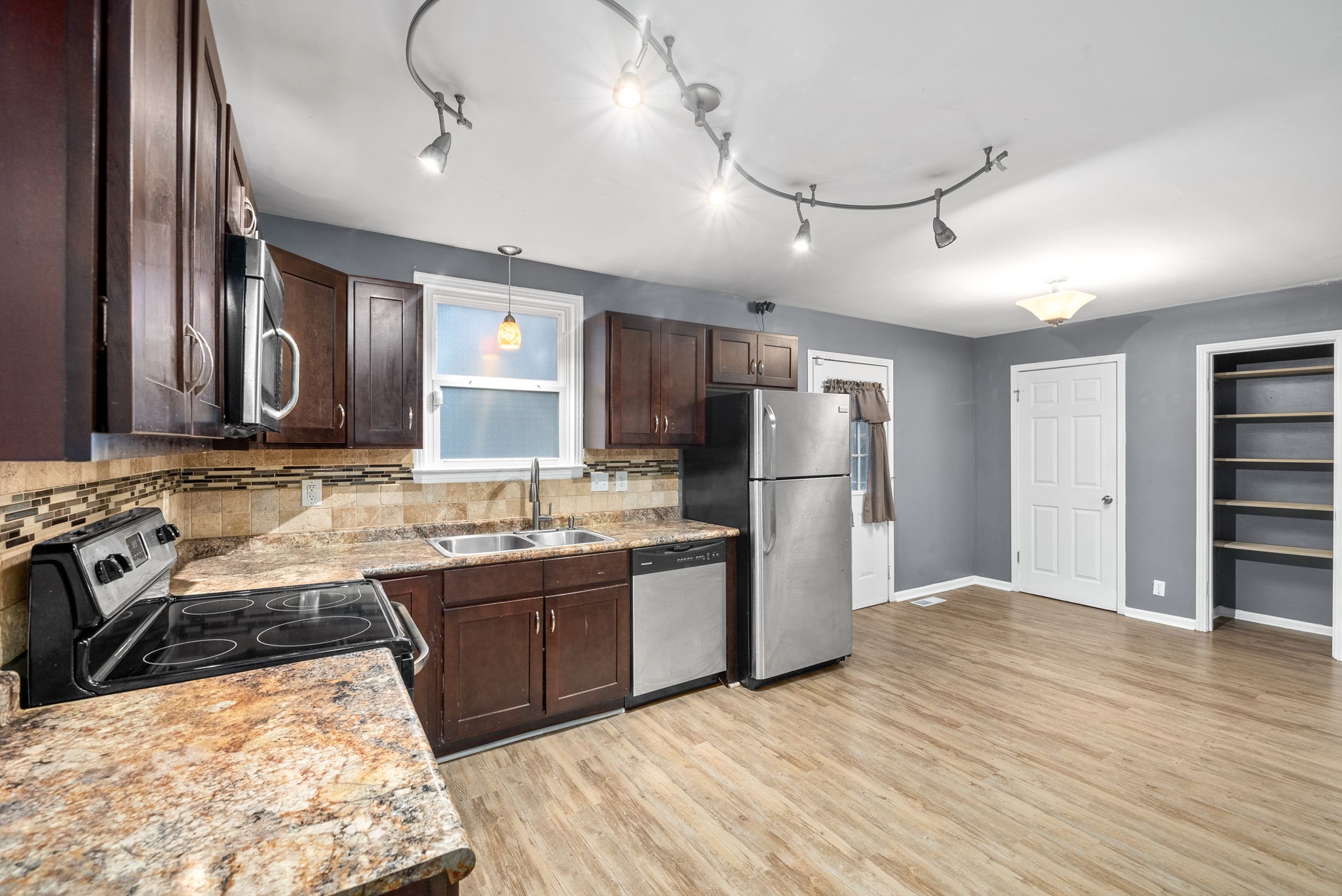 832 Pollard Road Clarksville, TN 37042 - Photo 11 of 30 a kitchen with stainless steel appliances granite countertop a sink stove and refrigerator