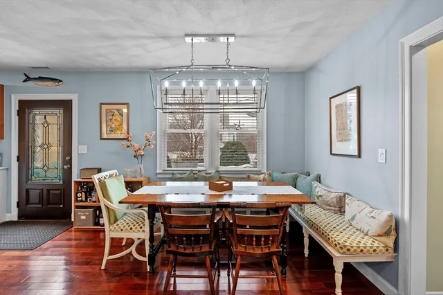 a view of a dining room with furniture wooden floor and chandelier