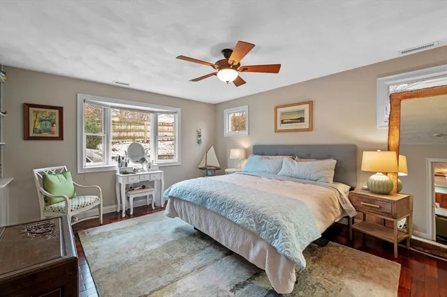 a bedroom with a bed a table and chair