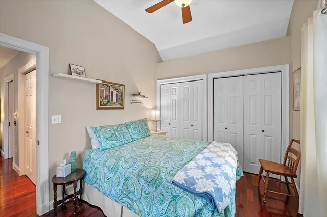 a bedroom with a bed and a chair in it