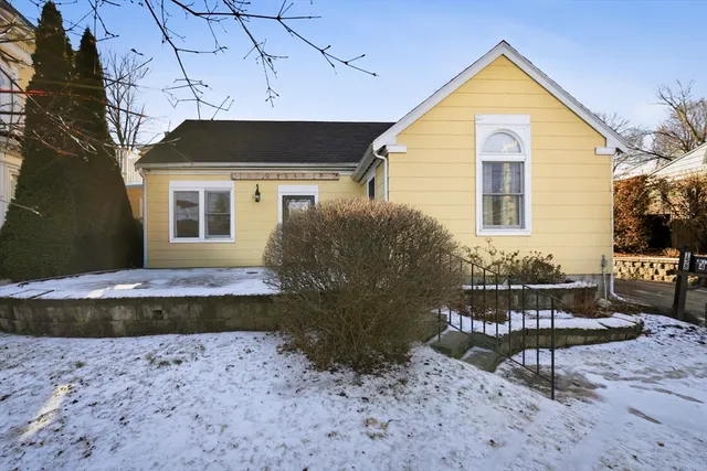 a view of a house with backyard and sitting area