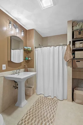 a bathroom with a sink a mirror and a shower