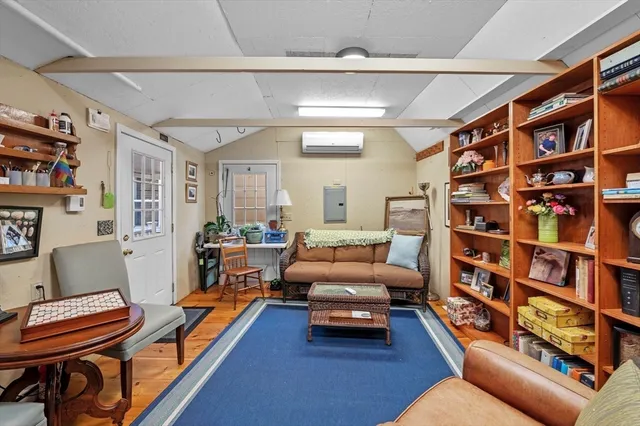 a living room with furniture and a book shelf