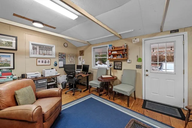 a living room with furniture a rug and a window