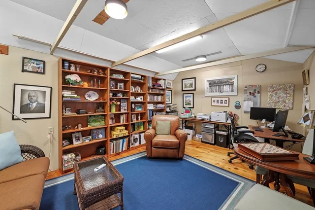 a living room with furniture workspace and a bookshelf