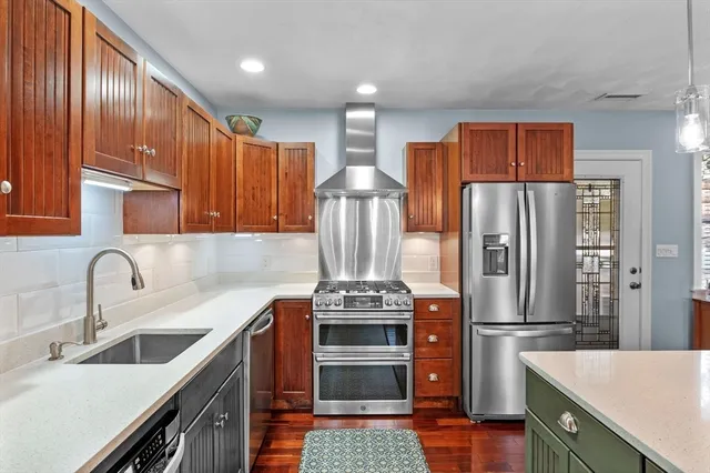 a kitchen with stainless steel appliances a refrigerator and a sink