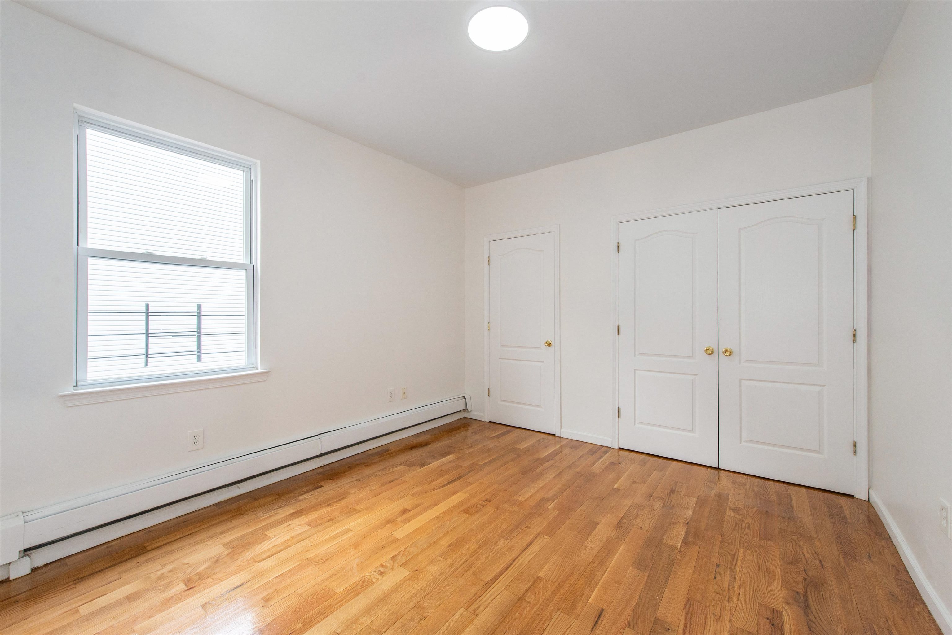 263 South 10th Street, Unit 2 Newark, NJ 07103 - Photo 13 of 22 an empty room with a empty space and windows