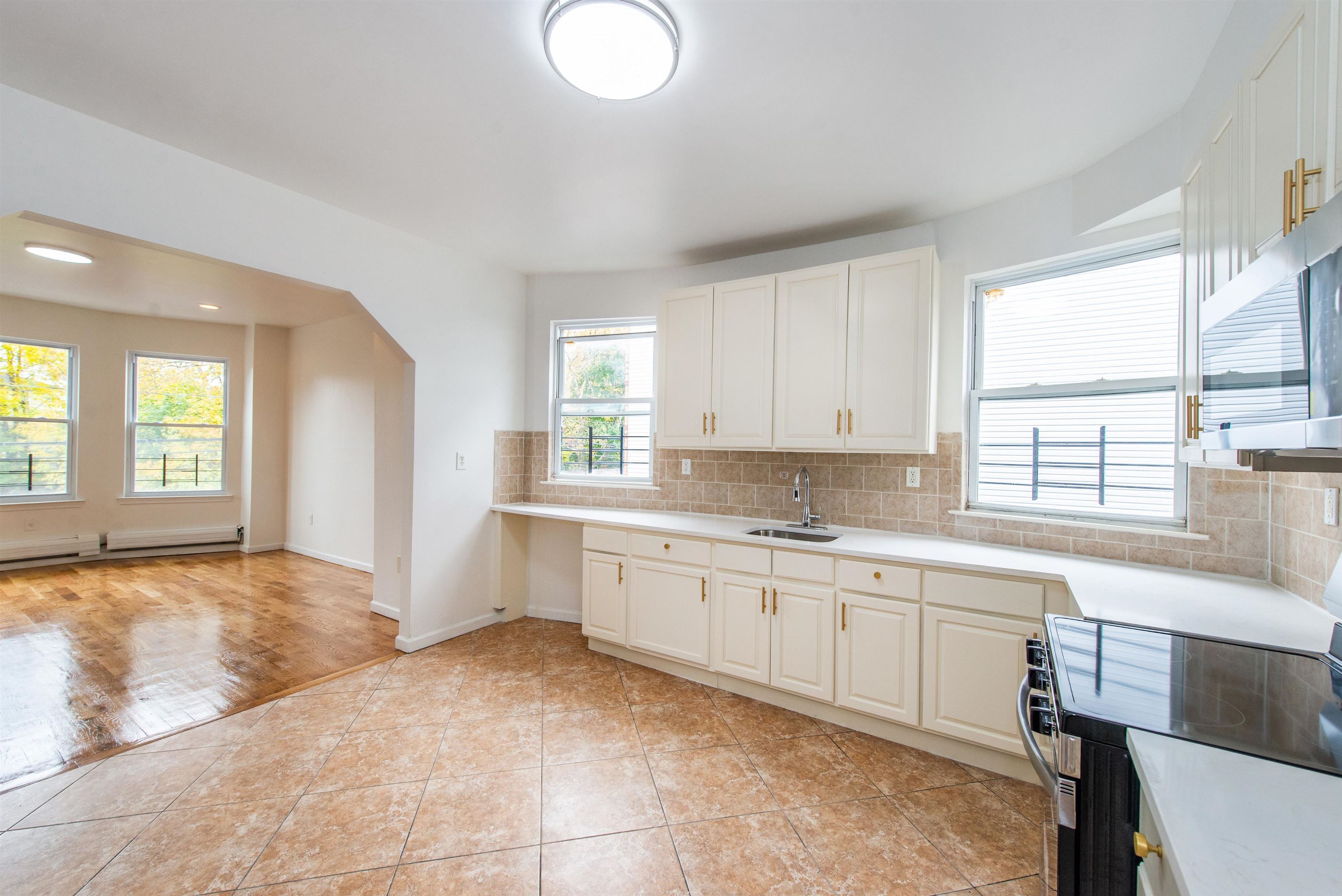 263 South 10th Street, Unit 2 Newark, NJ 07103 - Photo 6 of 22 a large bathroom with a sink and a bathtub
