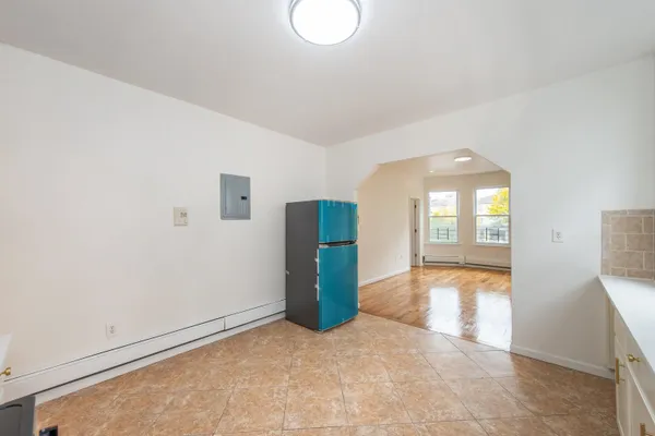 an empty room with entrance and windows