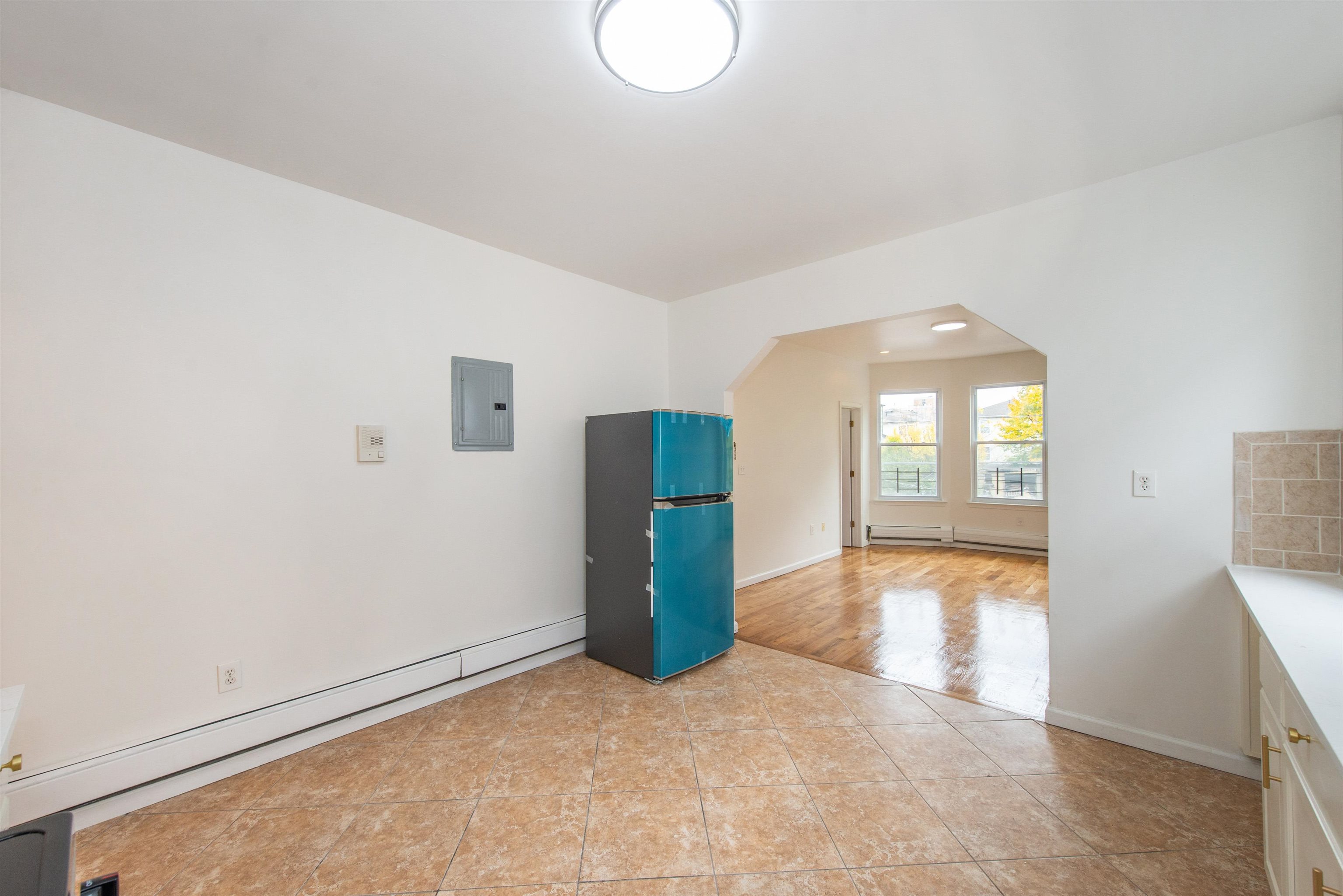 263 South 10th Street, Unit 2 Newark, NJ 07103 - Photo 8 of 22 an empty room with entrance and windows