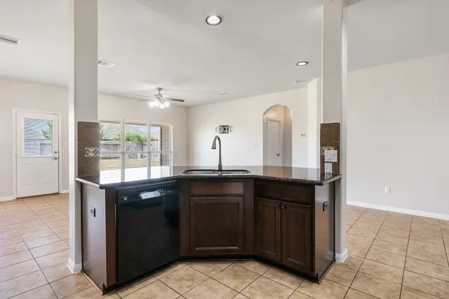 a kitchen with granite countertop a sink and cabinets