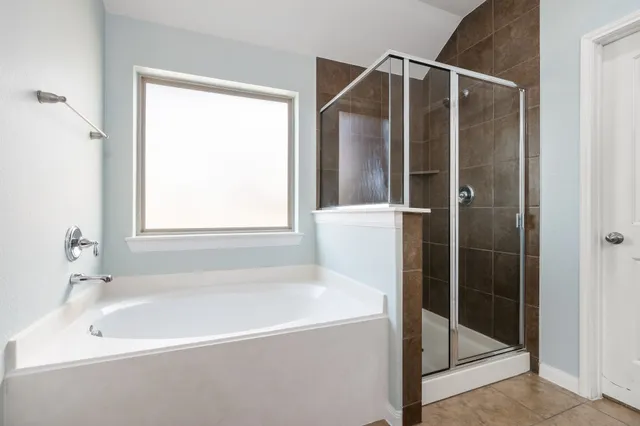 a bathroom with a bathtub and a shower