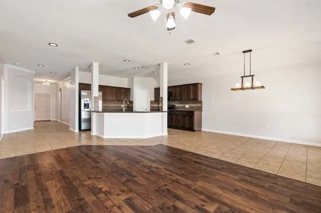 a view of a kitchen with a sink and a refrigerator