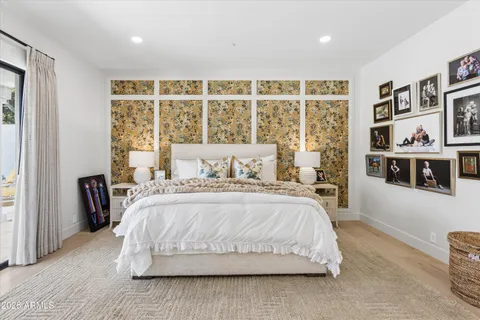 a spacious bedroom with a large bed and a large window