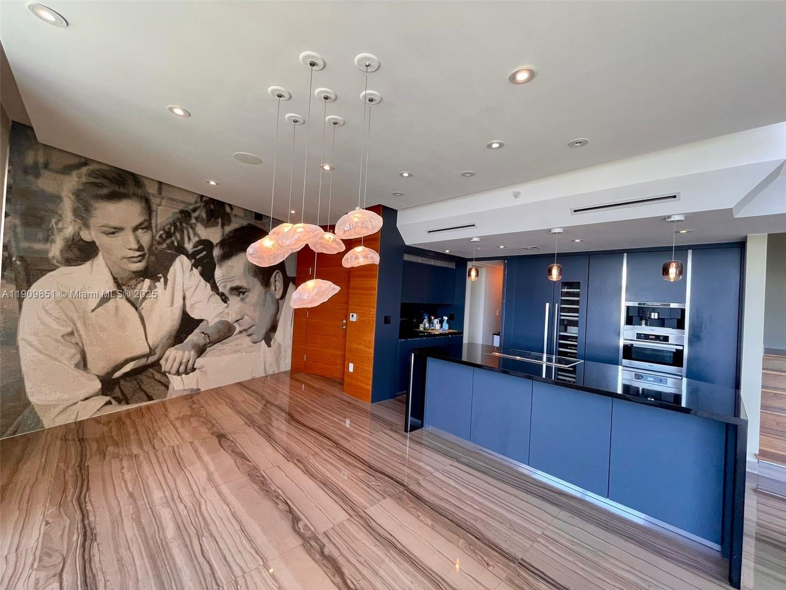 a view of a living room with furniture and wooden floor