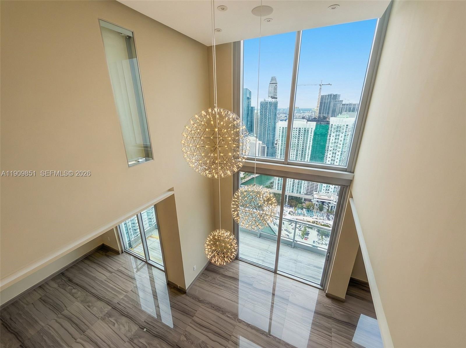 92 Southwest 3rd Street, Unit PH5213 Miami, FL 33130 - Photo 13 of 24 a view of entryway with wooden floor and door