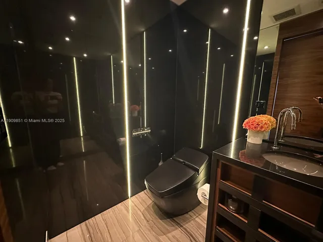 a bathroom with a mirror and a shower