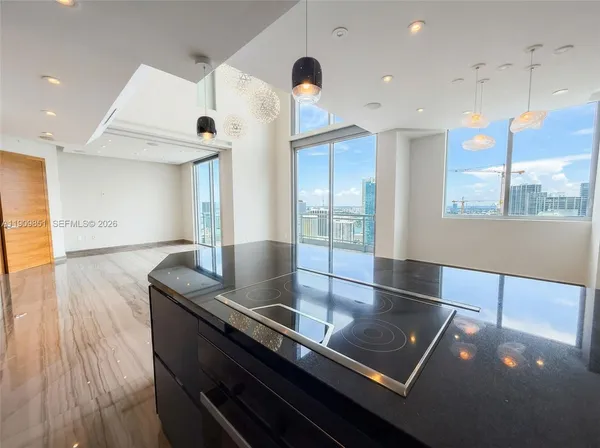 a view of kitchen and dining room with wooden floor