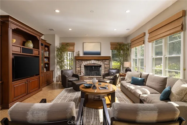 a living room with furniture a fireplace and a flat screen tv