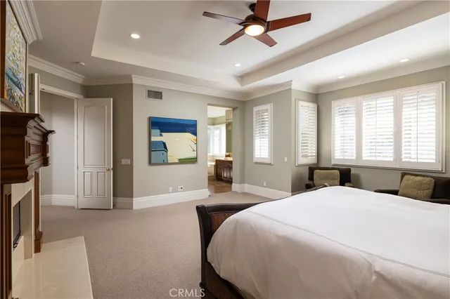 a bedroom with a large bed and a chandelier