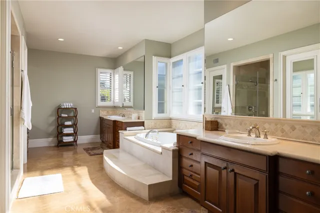 a spacious bathroom with a sink mirror and a bathtub