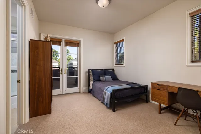 a bedroom with a bed and a desk