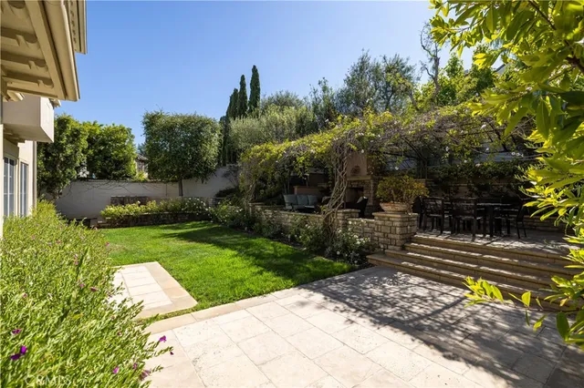 a view of a garden with a bench in a garden