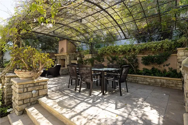 a view of a patio with table and chairs and potted plants