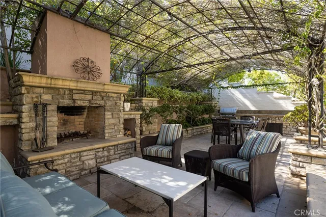 a outdoor living space with furniture and a fireplace