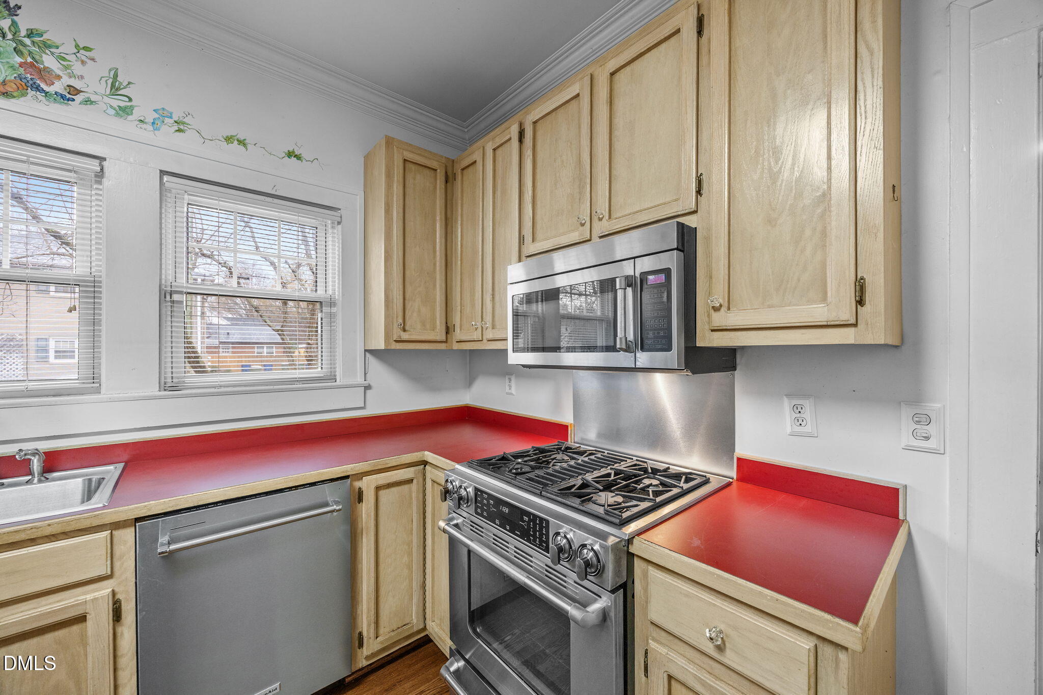 511 North Main Street Graham, NC 27253 - Photo 10 of 42 a kitchen with stainless steel appliances granite countertop a stove and a microwave