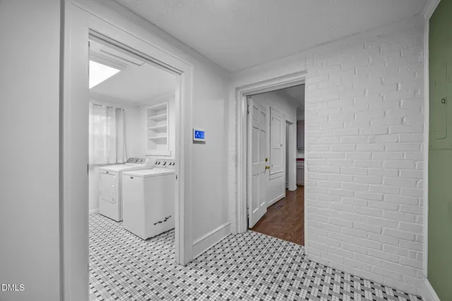 a view of a hallway with wooden floor and stairs