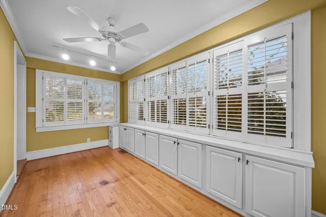 an empty room with fireplace and fan