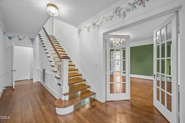 a view of entryway with stairs and wooden floor