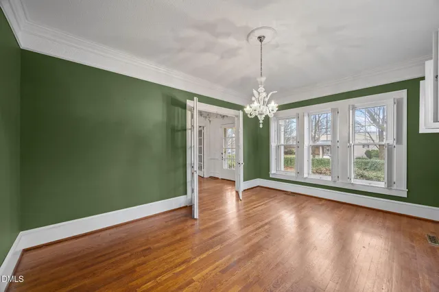 a view of a room with window wooden floor and chandelier